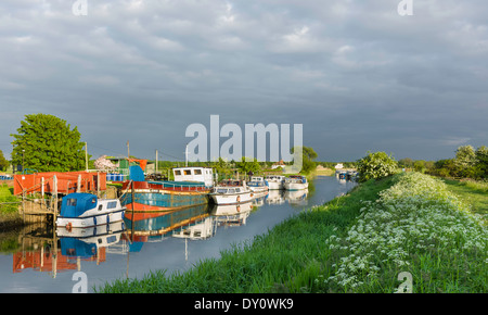 Boats and barges moored along the river Hull at sunset on a fine spring evening on June 01, 2013 at Tickton, near Beverley, York Stock Photo