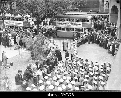 This 1937 photograph by Sam Hood captures the Adelaide Boys' Band arriving at Central Railway Station in Sydney. The image highlights a cultural event and the role of music in community life during the 1930s. Stock Photo