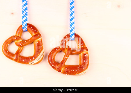 Two pretzel in heart shape on wood background, top view Stock Photo