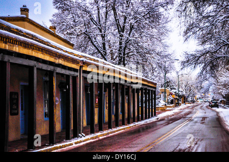 A slushy melting snow view of the storefronts along the Portico on Palace Avenue in downtown Santa Fe, NM Stock Photo