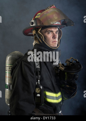 Male firefighter in structural firefighting uniform with breathing ...