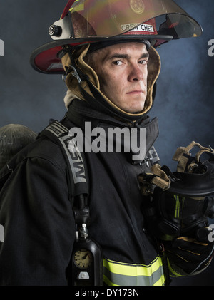 Male firefighter in structural firefighting uniform with breathing ...