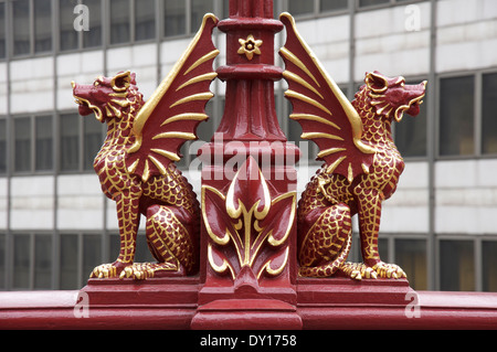 Ornate red gryphons, with details picked out in gold leaf, adorn the Victorian lamp posts on the Holborn Viaduct in the City of London. England, UK. Stock Photo