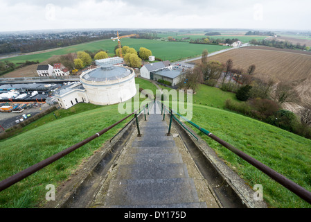 Steps leading to the top of the Lion's Mound (Butte du Lion), an artificial hill built on the battlefield of Waterloo to commemorate the location where William II of the Netherlands was injured during the battle. The hill is situated on a spot along the line where the Allied army under the Duke of Wellington's command took up positions during the Battle of Waterloo. The white cylindrical building is the Panorama, while construction of other buildings is going on in anticipation of the 200th anniversary in June 2015. Stock Photo