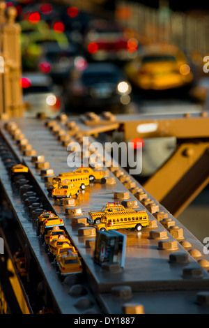 New York yellow taxi cabs and school buses souvenirs on Brooklyn bridge Stock Photo