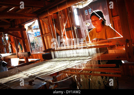 Unidentified woman was weaving silk fabric Stock Photo