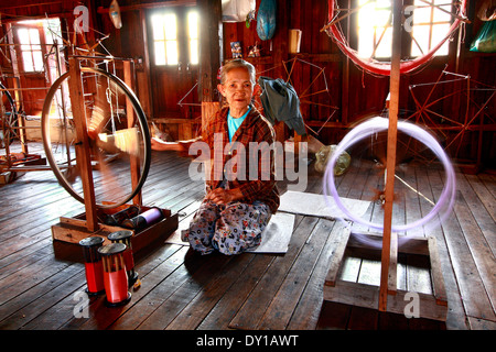 Unidentified woman was weaving silk fabric Stock Photo