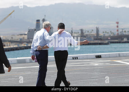Honolulu, USA. 2nd April, 2014. U.S. Defense Secretary Chuck Hagel (L) talks with Malaysian Defense Minister and acting Transport Minister Hishammuddin Hussein on the flight deck of the USS Anchorage, an amphibious transport dock ship at Joint Base Pearl Harbor-Hickam in Honolulu, Hawaii, the United States, April 2, 2014. U.S. Defense Secretary Chuck Hagel on Wednesday pledged to continue providing U.S. assistance for the search for missing Malaysia Airlines Flight MH370. Stock Photo