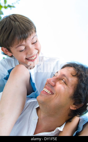 Portrait of young happy father getting  busy with his son Stock Photo