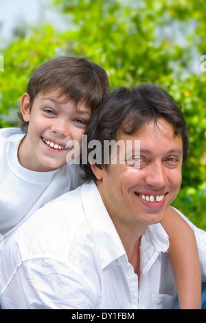 Portrait of young happy father getting  busy with his son Stock Photo