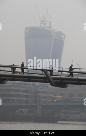 London, UK. 3rd April, 2014. London Smog: Millennium Bridge, City of London, London, UK Commuters make their way across the Millennium Bridge as the London Smog, and red dust swept up from the Sahara continue to cause high levels of air pollution across the capital. Scores of flights have been cancelled and people have been advised to stay indoors if they suffer from asthma or heart conditions. Credit:  Jeff Gilbert/Alamy Live News Stock Photo