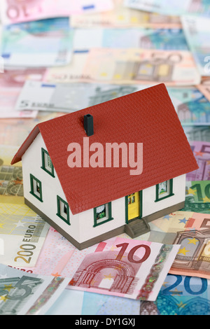 Symbolic picture for home financing with a building on Euro notes Stock Photo