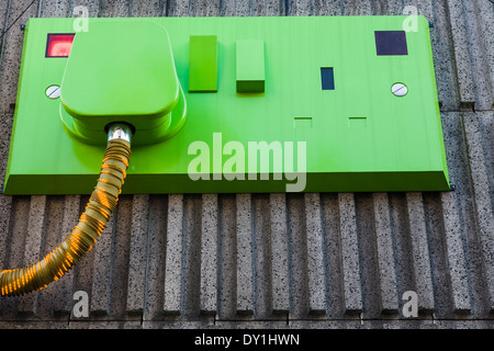 Giant electricity plug decorates a building wall in Soho, London. Stock Photo