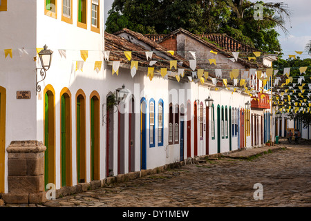 Paraty, colonial town, typical colonial houses in a cobblestone paved street, flags, Rio de Janeiro, Costa Verde, Brazil Stock Photo