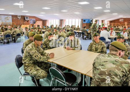 Soldiers sit around tables in a barracks mess. Stock Photo