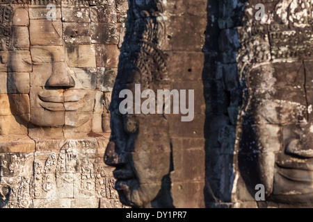 Three sculptured stone faces in Bayon Temple in Angkor near Siem Reap, Cambodia Stock Photo