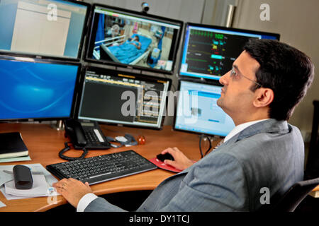 Bangalore, India. 3rd Apr, 2014. A staff member shows the innovation of connected healthcare system in Bangalore, India, April 3, 2014. Electronics company Royal Dutch Philips on Thursday released a range of innovations which specially developed for South Asia at the Philips Innovation Center in Bangalore of India. © Chen Xuelian/Xinhua/Alamy Live News Stock Photo