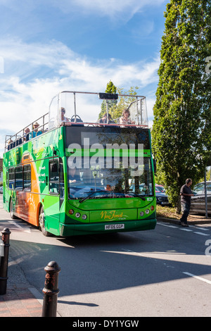 Sightseers on an open top double-decker tour bus. New Forest, Lyndhurst, Hampshire, England, GB, UK. Stock Photo