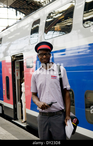 African French train conductor of TGV, Paris, France Stock Photo