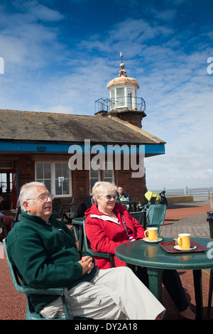 UK, England, Lancashire, Morecambe, Stone Jetty, couple drinking coffee at lighthouse cafe Stock Photo