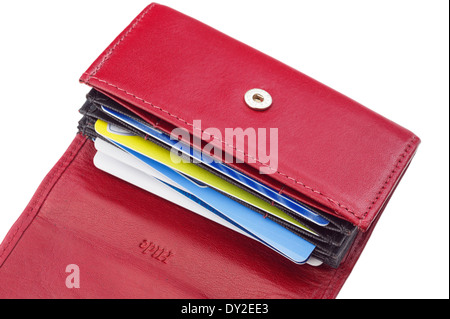 An open red leather wallet credit card holder containing bank cards on a white background. England UK Britain Stock Photo