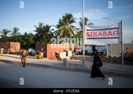 Pedestrians walk past the construction site of Austrian construction company Strabag in Dar es Salaam, Tanzania, 25 March 2014. Construction constractor Strabag is currently building a bus rapid transport terminal in Dar es Salaam. Photo: Michael Kappeler/dpa Stock Photo