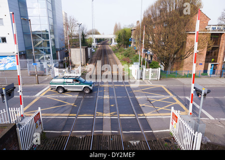 Looking down on railway level crossing with barriers up. Stock Photo