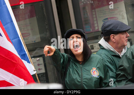 London, UK. 4th April 2014. A Woman from right wing anti-Islamist group Britain First screams abuse as Anjem Choudary's Need For Khilafah group demonstrate near the Lebanese embassy against what they say is 'the entire Muslim community being put under siege in North Lebanon'. Credit:  Paul Davey/Alamy Live News Stock Photo