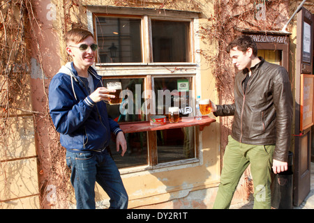 Prague Bar U zavesenyho kafe, Prague boys drinking beer outside a bar,  Lesser Town, Prague Mala Strana Czech Republic Stock Photo