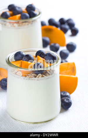 Two glasses of yogurt with granola and berries Stock Photo