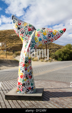Whale tail, flukes, street art sculpture at traffic circle in Puerto Piramides, Argentina. Stock Photo