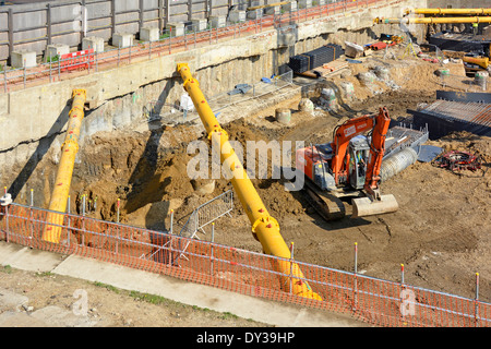 Diagonal shoring struts in pace across corners of retaining walls on large construction site Stock Photo