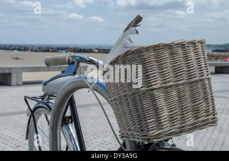 granny bicycle was found leaning against the railing overlooking the dunes, beach and cantabrian Sea