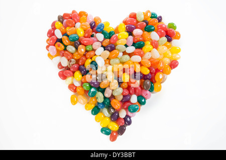 Heart formed out of jelly beans on a clean white backdrop: Sweetheart Stock Photo