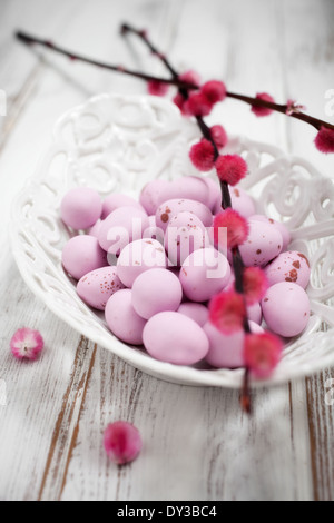 Pink Easter chocolate eggs in white bowl Stock Photo