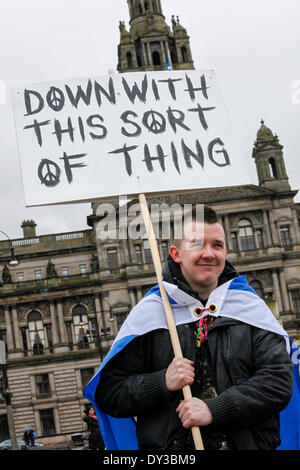 Glasgow, Scotland, UK. 5th April 2014. Almost 1000 supporters of Scottish Campaign for Nuclear Disarmament (CND) and the Pro-Independence for Scotland campaigners braved heavy rain and adverse weather conditions to collectively take part in a good humoured rally in George Square, Glasgow, Scotland, UK Campaigners attended from across Scotland and intend to take their protests to Faslane Naval Base, Gairloch, Scotland on Monday 7th April 2014. Credit:  Findlay/Alamy Live News Stock Photo