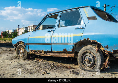 Abandoned old rusty car on the meadow. Stock Photo