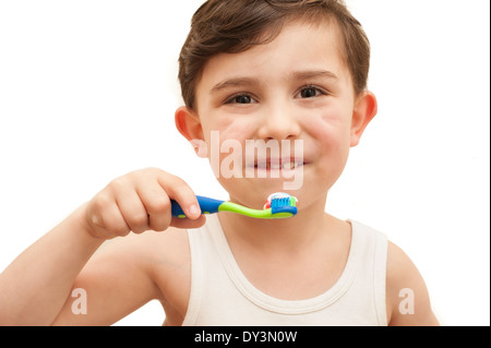 Young boy brushing his teeth on an isolated background Stock Photo