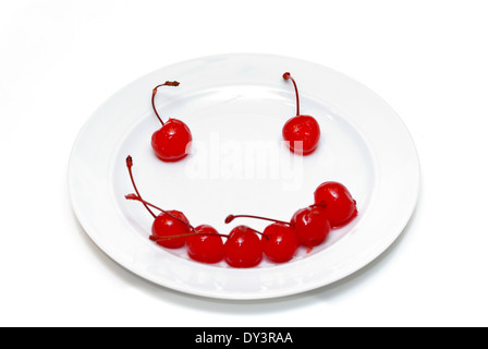 A smiley face made from bright red cherries. Stock Photo