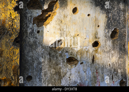 Holes in wall of old building, evidence of the brutal civil war between the Tamil Tigers and the Sri Lankan government Stock Photo