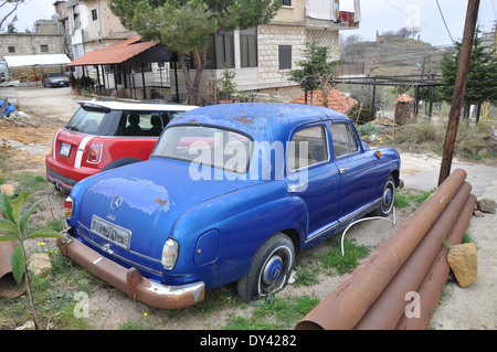 Mercedes Benz c180 next to new BMW mini in village outside Beirut, Lebanon Stock Photo