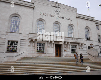 Pedestrians walking down the steps of Hackney Town Hall in London, United Kingdom. Daily activity outside the Grade II listed civic building in East London Stock Photo