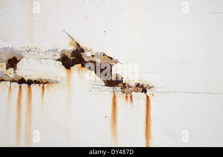 old white metal door with peeling paint and rusty streaks Stock Photo