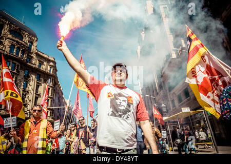 Barcelona, Spain. April 6th, 2014: A protestor from the French CGT holds a bengal fire during a march for a social Catalonia through the city of Barcelona. Credit:  matthi/Alamy Live News Stock Photo