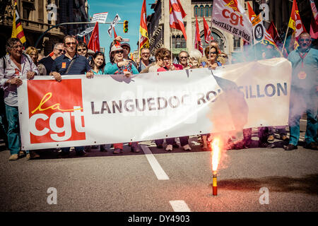 Barcelona, Spain. April 6th, 2014: A bengal fire is burned in front of protestors from France during a march for a social Catalonia through the city of Barcelona. Credit:  matthi/Alamy Live News Stock Photo