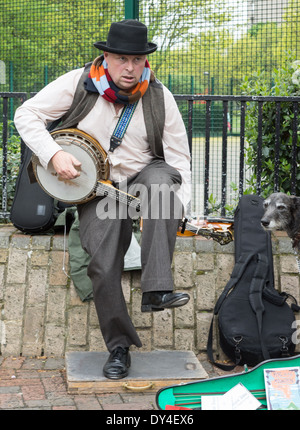 street musician playing banjo. London busker. Stock Photo