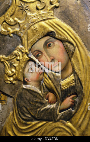 Fragment of domestic Ukrainian icon covered in oklad (riza), Museum of domestic Ukrainian icons in Radomyshl Castle, Ukraine Stock Photo