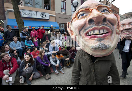 Ann Arbor, MI, USA. 6th Apr, 2014. Papier-mache puppets march down Main Street during the annual Festifools Parade, which begins the season of festivals in Ann Arbor. University of Michigan students and local residents build the creative public art pieces and bring them to life in front of thousands of Ann Arborites every spring. Credit:  Mark Bialek/ZUMAPRESS.com/Alamy Live News Stock Photo
