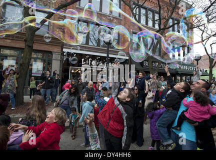 Ann Arbor, MI, USA. 6th Apr, 2014. After a long winter, life is once again good on Main Street in Ann Arbor as the annual Festifools Parade takes place. University of Michigan students and local residents build creative papier-m''°chÅ½ public art pieces and bring them to life in front of thousands of Ann Arborites every spring to kick off the festival season. Shown here, kids have fun with giant soap bubbles toward the end of the event. Credit:  Mark Bialek/ZUMAPRESS.com/Alamy Live News Stock Photo