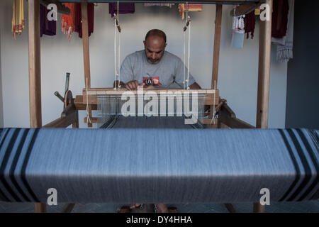 Manama, Bangladesh. 6th April, 2014. Woman sews clothes embroidered ...